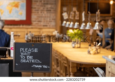 Please wait to be seated at the table