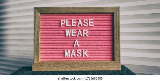 Please Wear A Mask Pink Sign At Business Store Entrance Message. Obligatory Wearing Of COVID-19 Protection Face Cover.