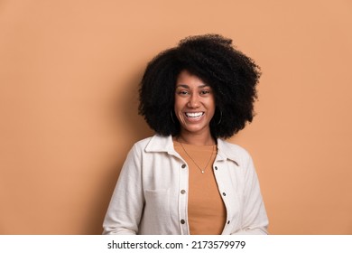 Pleased Black Woman Smiling Wearing White Jacket In Studio Shot. Portrait, Real People Concept.