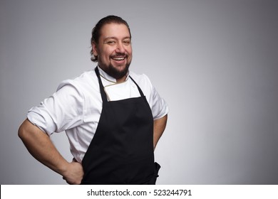 Pleased chef looking confidently at the camera and laughing. Professional approach to business - Powered by Shutterstock