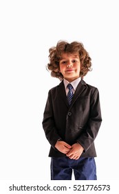 Pleased Curly Boy Looks At The Camera In A Business Suit. White Background.