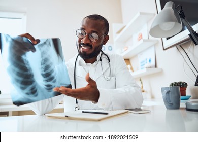 Pleased Medical Worker Asking Another Person To Have A Look At The X-ray Chest Diagram