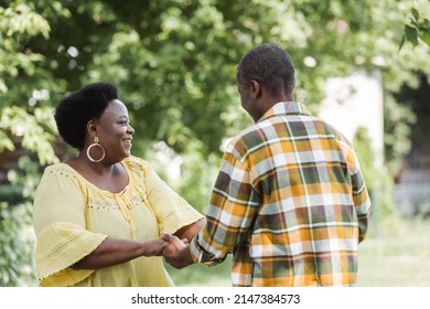 Pleased Senior African American Couple Dancing In Park