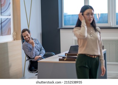 Pleased young boss staring after his secretary - Shutterstock ID 2152538935