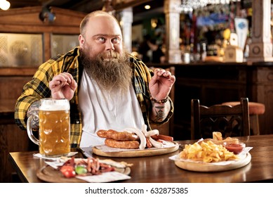 Pleasure Bearded Man Eating Food In Boozer