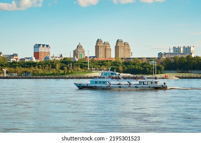 A Pleasure Boat Moves Down The River With The Embankment Of Heihe, China In The Background. Beautiful Blue Sky With Clouds. State Border Between Russia And China. Summer Evening.