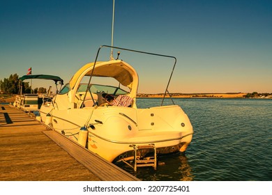 Pleasure Boat At The Pier - Rear View. Boat Trips On The River At Sunset