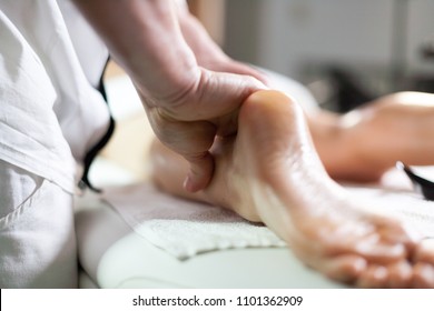 Pleasure of manipulation Ayurvedic massage therapist working on the legs of a woman greased with scented and warm oil. Alternative ayurveda ayurvedic body business card closeup concept conscio