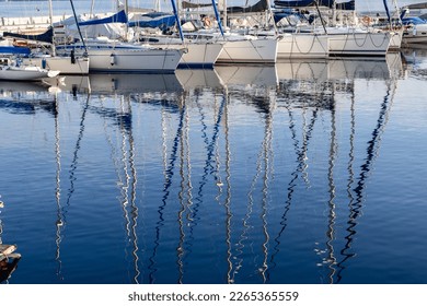 Pleasure yacht masts in the water reflection on Lake Garda in Italy - Powered by Shutterstock