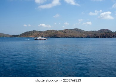 Pleasure Yacht In The Sea. Tourist Ship With People On Board With Turkish Flag Sails On The Waves. Fast Moving Excursion Ship Boat. Marmaris, Turkey - September 9, 2022