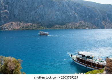 Pleasure Yacht In The Sea. Tourist Ship With People On Board With Turkish Flag Sails On The Waves. Fast Moving Excursion Ship Boat. Marmaris, Turkey - September 9, 2022