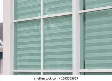 Pleated Paper Blinds Under Glass Home Windows. White Modern Home Blinds.