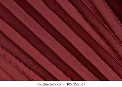 Pleated satin fabric texture in wine red