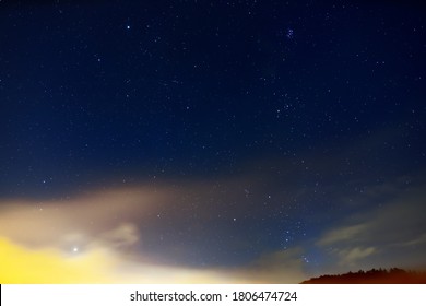 The Pleiades, Orion Constellation And Venus In The Stormy Sky.