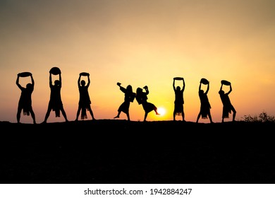 Pleiku Town, Gia Lai Province, Vietnam - March 6, 2021: Ede Boys And Girls Perform Their Traditional Dance During Their Sunset Period In Pleiku Town, Gia Lai Province, Vietnam. Silhouette.