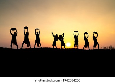 Pleiku Town, Gia Lai Province, Vietnam - March 6, 2021: Ede Boys And Girls Perform Their Traditional Dance During Their Sunset Period In Pleiku Town, Gia Lai Province, Vietnam. Silhouette.