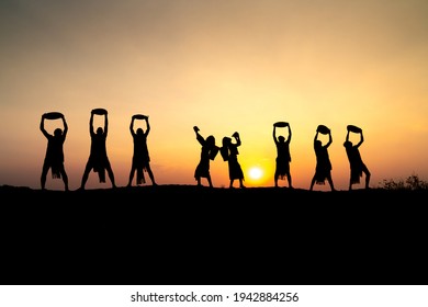 Pleiku Town, Gia Lai Province, Vietnam - March 6, 2021: Ede Boys And Girls Perform Their Traditional Dance During Their Sunset Period In Pleiku Town, Gia Lai Province, Vietnam. Silhouette.