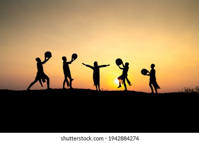 Pleiku Town, Gia Lai Province, Vietnam - March 6, 2021: Ede Boys And Girls Perform Their Traditional Dance During Their Sunset Period In Pleiku Town, Gia Lai Province, Vietnam. Silhouette.