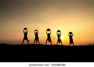 Pleiku Town, Gia Lai Province, Vietnam - March 6, 2021: Ede Boys And Girls Perform Their Traditional Dance During Their Sunset Period In Pleiku Town, Gia Lai Province, Vietnam. Silhouette.