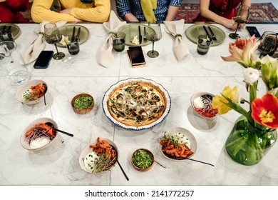 Plenty Of Food On Plates On The Table For A Large Group Of Family Or Friends. Dinner Top View.