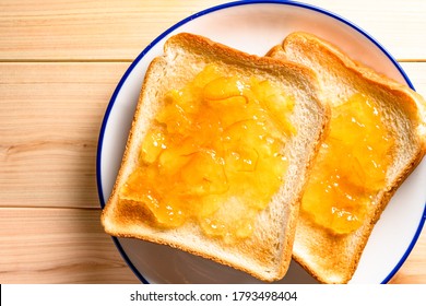 the plenty orange marmalade on the toast.