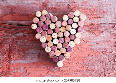Plenty of Wine Bottle Corks Formed in Heart Shape for Love Concept on Top of an Old Wooden Table in High Angle View.