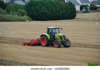 PLERIN, FRANCE -August 13 2018 : Tractor Passing Chisel Plow At Plerin