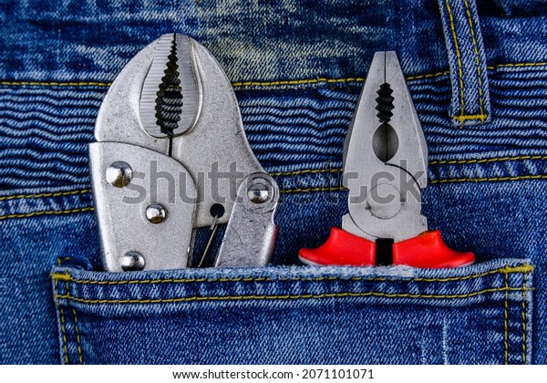 Pliers and locking pliers in rear pocket of jeans.\
Top view