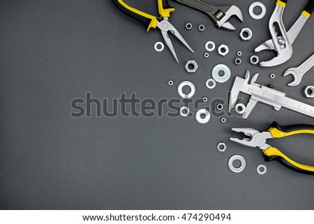pliers, spanner with adjustable wrench and vernier caliper on craftsmen table background 