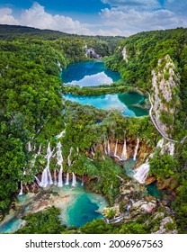 Plitvice, Croatia - Panoramic view of the beautiful waterfalls of Plitvice Lakes in Plitvice National Park on a bright summer day with blue sky and clouds and green foliage and turquoise water - Shutterstock ID 2006967563