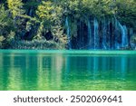 Plitvice Lakes National Park. Croatia. Big waterfalls. Nature travel background. Beautiful summer nature. Plitvice waterfalls in Croatia. Lake in deep forest. Turquoise Lakes.