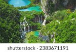 Plitvice Lakes and waterfalls in National Park Croatia. Summer mountain landscape with streams, emerald green water.