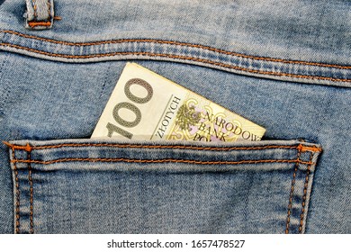 PLN 100 in a jeans pocket. Close up view. Selective focus. Polish money in the jeans pocket. Banknote sticking out from back pocket of trousers - Powered by Shutterstock