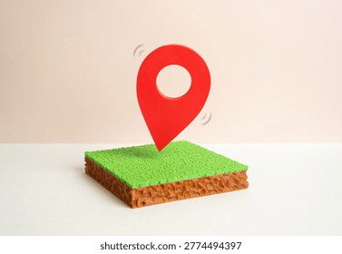 A plot of land with a red geolocation marker. Land market and cadastral registers. Buying and selling land. Geographic survey and boundary delineation.