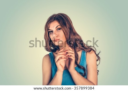 Plotting. Closeup portrait of sneaky, sly, scheming young woman trying to plot something, screw someone isolated green wall background. Negative human emotions, facial expressions, feelings, attitude