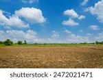 Ploughed field  blue sky and clouds, rural india 