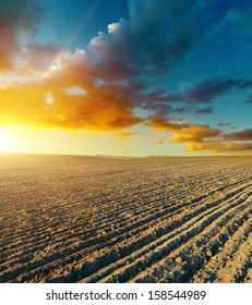 Ploughed Field And Sunset