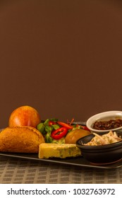 Ploughman's Lunch With Stilton Cheese, Pickle, Pickled Onion, Salad, Cole Slaw And Bread Roll And Apple. Copyspace Above.