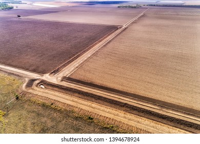 Plowed cultivated farm fields around Moree argicultural town in Australian wheat belt on top of artesian basin in NSW. Aerial elevated view over ground black soils.