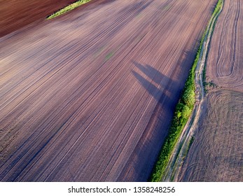 Plowed cultivated spring time agriculture field, aerial