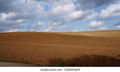 Plowed Field With Hilly Terrain