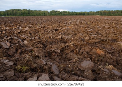 plowed field with tractor traces in spring time, farm soil background. Selective focus - Shutterstock ID 516787423