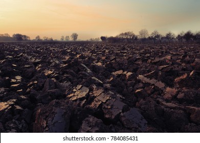 Plowed Soil. Spring Field. Sunset Over Ploughed Field. Countryside Lanscape. Vintage Polaroid Filter Applied.