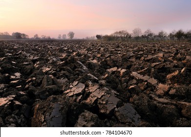 Plowed Soil. Spring Field. Sunset Over Ploughed Field. Countryside Lanscape. Vintage Polaroid Filter Applied.