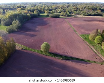 Plowed spring time agriculture fields in evening , aerial view from drone