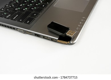Plug the removable flash drive into the laptop's USB slot. flash drive in laptop on a white background. 2 flash drives
