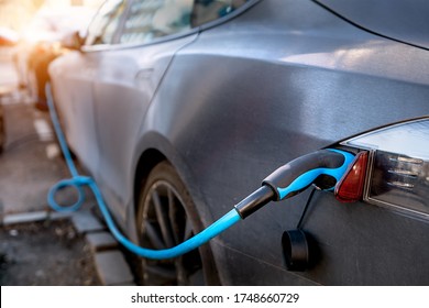 Plugging In Electric Car At Home Or Electric Charging Station.electrical Car Charging.