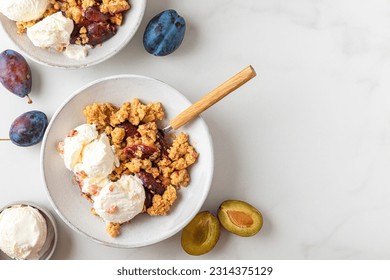 Plum crumble with vanilla ice cream on white background. Summer crispy fruit dessert. Top view with copy space - Powered by Shutterstock