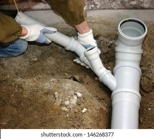 Plumber Assembling Pvc Sewage Pipes 