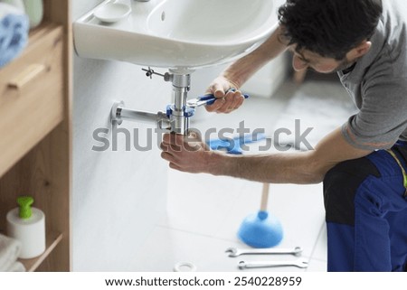 Plumber checking a bathroom sink drain and using water pump pliers